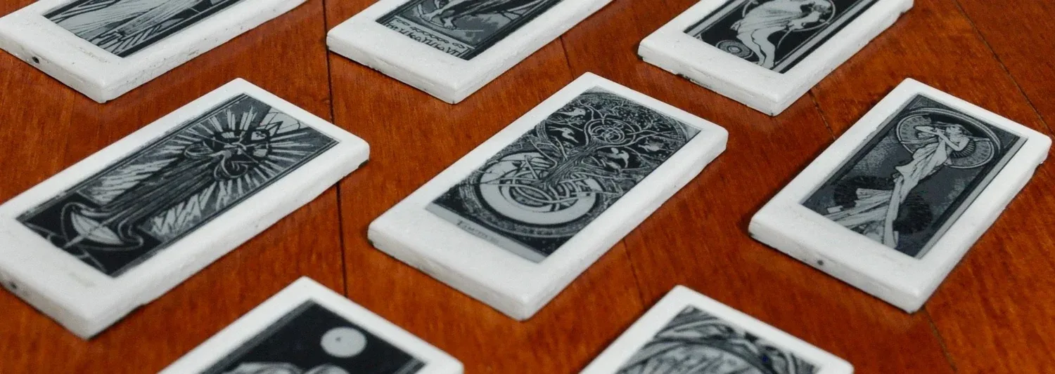Wyldcard e-paper cards laid out on a wooden table